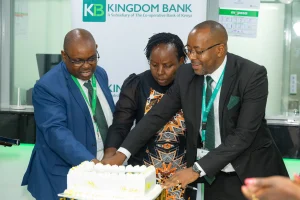 Kingdom Bank Managing Director & CEO Anthony Mburu (left) and Embu Branch Manager Moffat Njeru (right) join a customer in cutting a cake to mark the official opening of the Kingdom Bank Embu Branch.